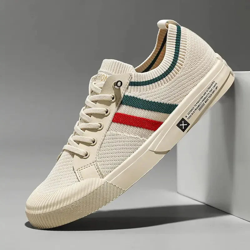 Side view of beige knit sneaker with green and red stripe, lace-up front and cream rubber sole