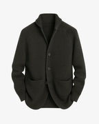 Olive green ribbed knit cardigan with notch lapel, three buttons and patch pockets, laid flat