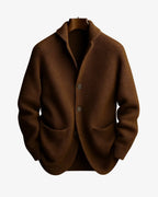 Brown ribbed knit cardigan with notch collar and patch pockets displayed on a wooden hanger