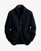 Navy ribbed knit tailored cardigan with notch collar and buttoned front on a wooden hanger