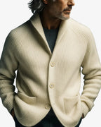 Front view of the terracotta ribbed knit cardigan buttoned, highlighting the tailored notch lapel