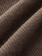 Macro shot of the dark brown knit fabric texture showing the soft ribbed weave up close