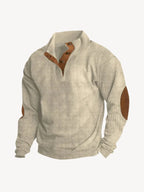 Beige ribbed quarter-zip jumper with tan leather button placket and suede elbow patches, front view