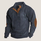 Dark blue ribbed knit quarter-zip jumper with tan leather trim and suede elbow patches