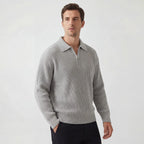 Man wearing a light grey ribbed knit zip polo jumper with contrast collar, front three-quarter view
