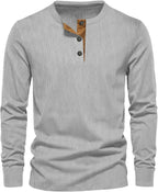 Light grey ribbed long-sleeve henley top with tan button trim at the neckline