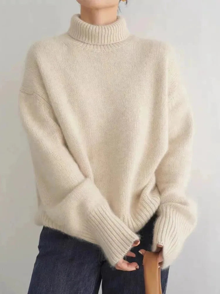 Front view of a cream polo neck jumper showing the chunky ribbed collar and drop-shoulder sleeves