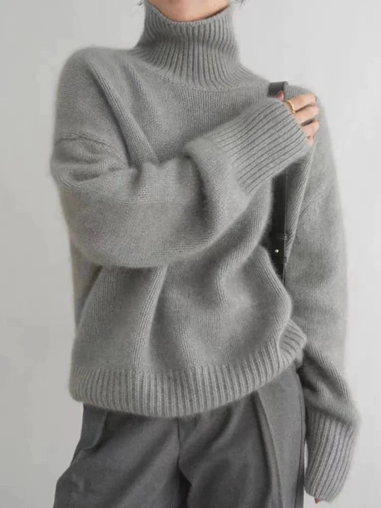 Grey roll neck jumper with ribbed hem and cuffs, styled with matching wide-leg trousers