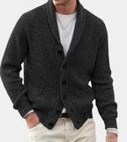 Charcoal grey shawl-collar cardigan in chunky ribbed knit, fastened with dark buttons and patch pockets