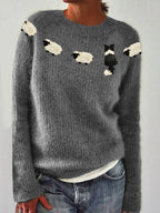 Close-up front view of grey knitted jumper with fuzzy sheep and border collie intarsia design across the chest