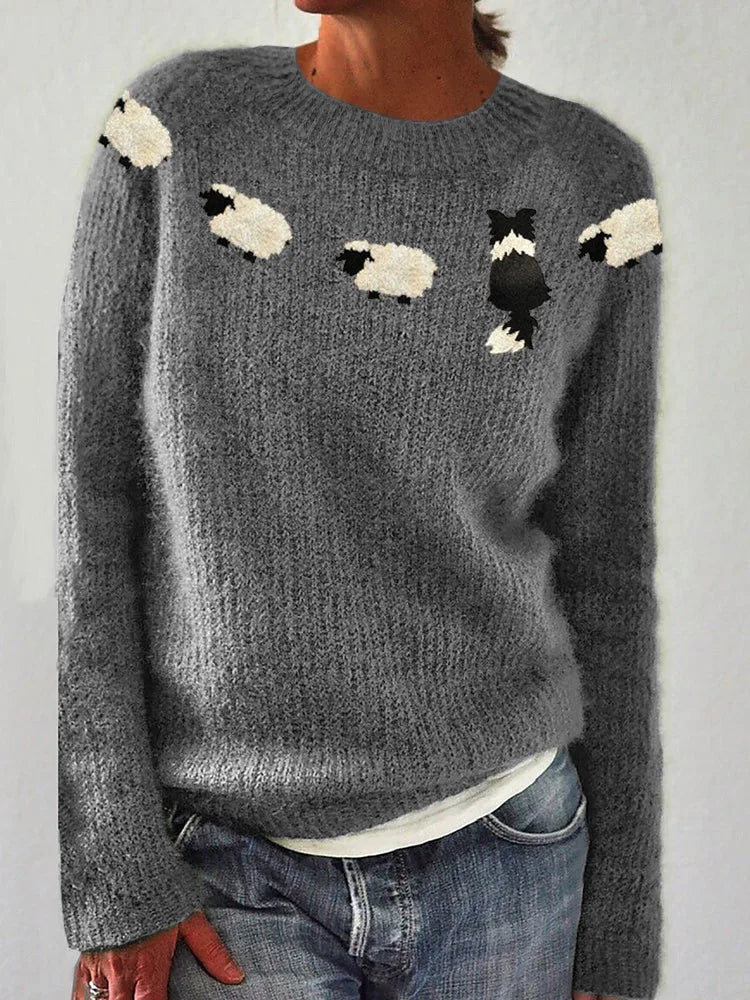 Close-up front view of grey knitted jumper with fuzzy sheep and border collie intarsia design across the chest