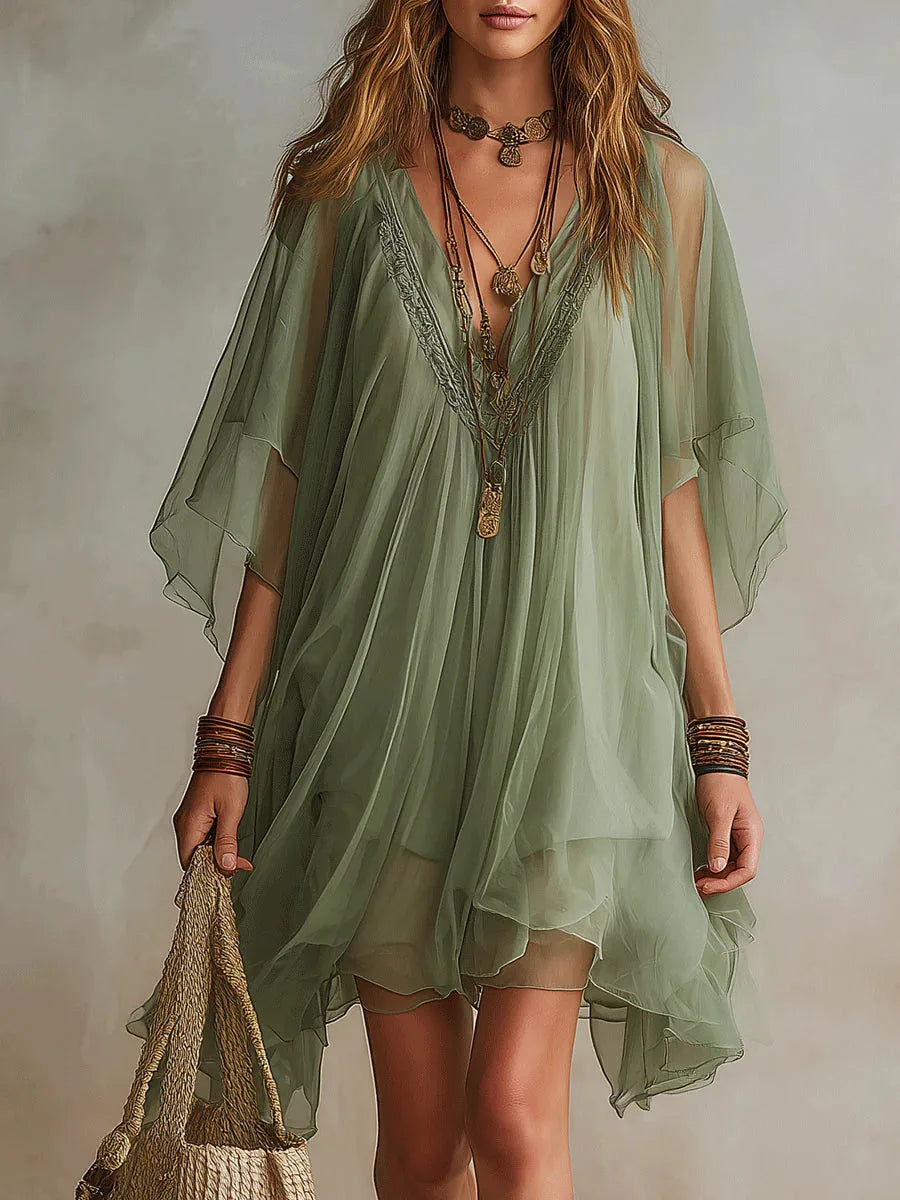 Close-up front view of the deep V-neckline with embroidered trim detail and layered chiffon bodice