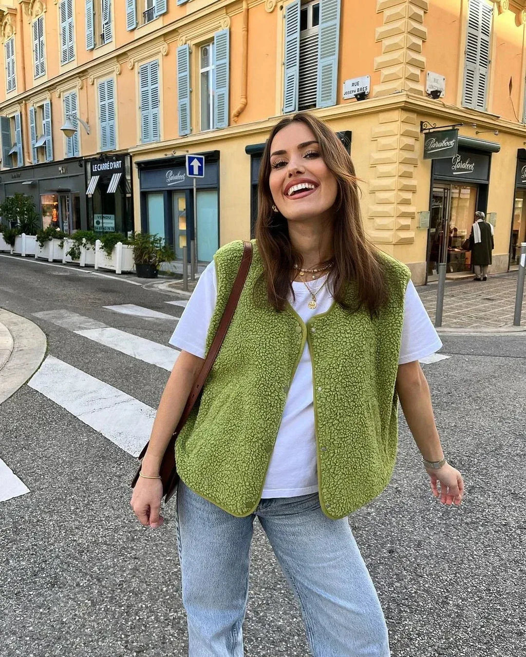 Side view of the green sherpa body warmer showing the snap button front and relaxed fit