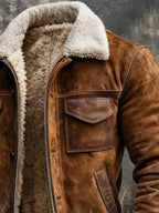 Close-up of the shearling collar and leather-trimmed flap pocket on the brown suede jacket