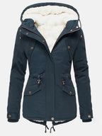Navy blue hooded parka with the zip half open, showing the cosy cream sherpa lining and popper cuffs.