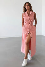 Front view of the blush pink denim maxi dress showing the collared neckline, chest flap pockets and side leg split.