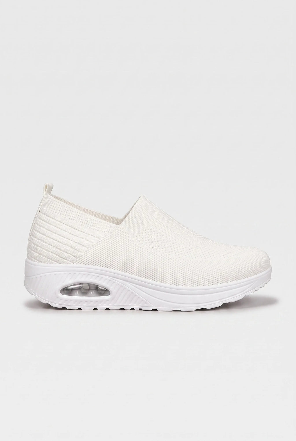 Side profile of white knit slip-on trainer with matching white cushioned wedge sole
