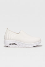 Side profile of white knit slip-on trainer with matching white cushioned wedge sole