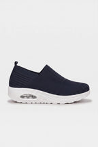 Side profile of navy blue knit slip-on trainer with contrasting white wedge sole and air-bubble unit