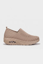 Side profile of light brown knit slip-on trainer with tonal wedge sole and ribbed side panel