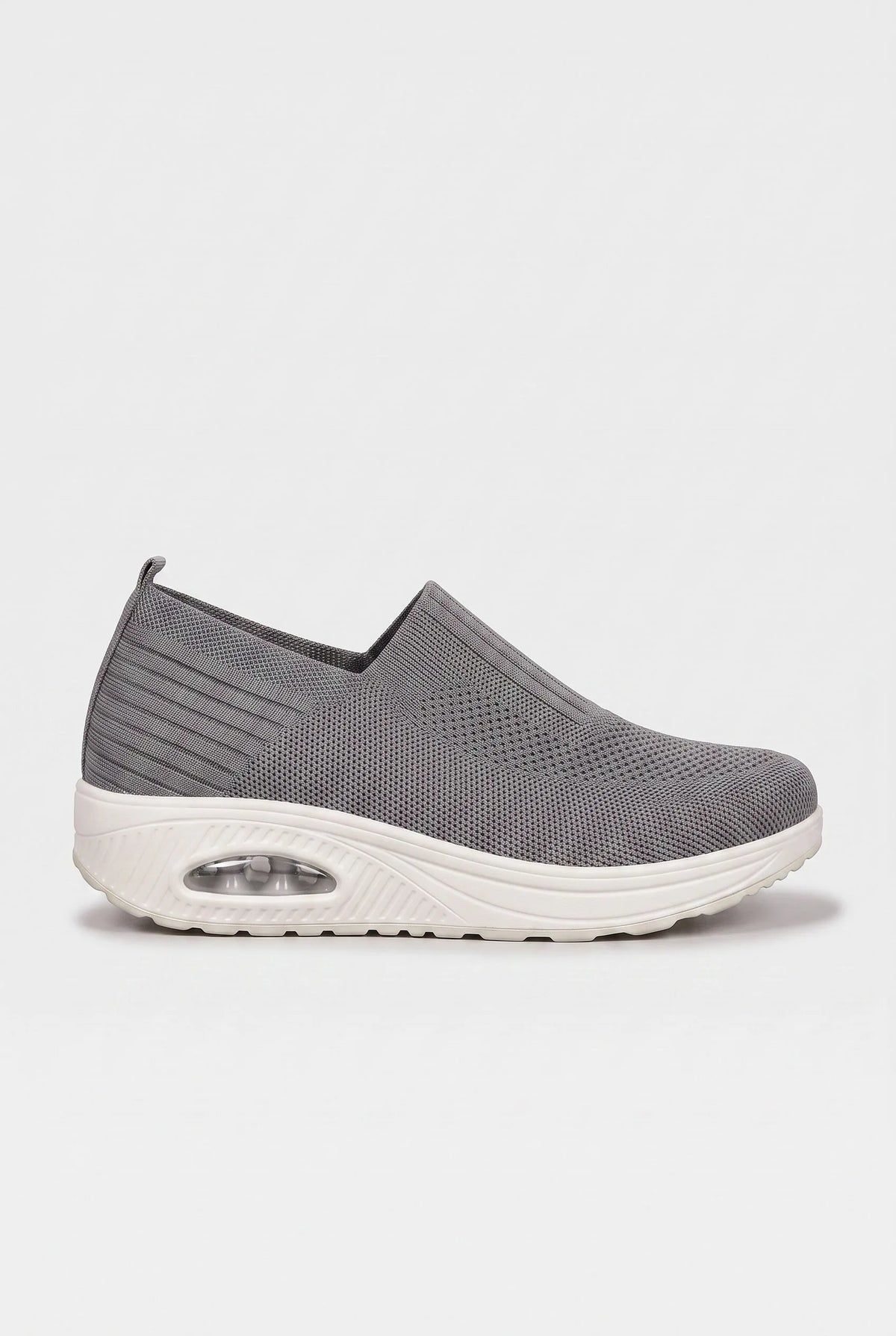 Side profile of grey knit slip-on trainer with contrasting white wedge sole and cushioned air unit