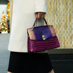 Close-up angle of the orange bag highlighting the contrast between the gold snake-effect flap and orange croc-effect leather