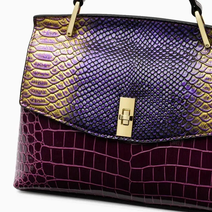 Close-up detail of the iridescent purple and gold snakeskin-effect flap with gold twist-lock clasp