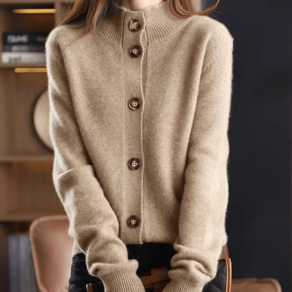 Beige cashmere cardigan with stand collar and five button closure, shown buttoned up to the neck