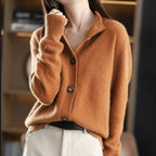 Rust orange cashmere cardigan with notched lapel collar, buttoned front and ribbed cuffs on the sleeve
