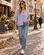 Lilac purple knitted cardigan with round neckline and button fastening styled with straight jeans and a white handbag