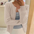 Beige knitted cardigan with fluffy texture, round neckline and ribbed cuffs worn open