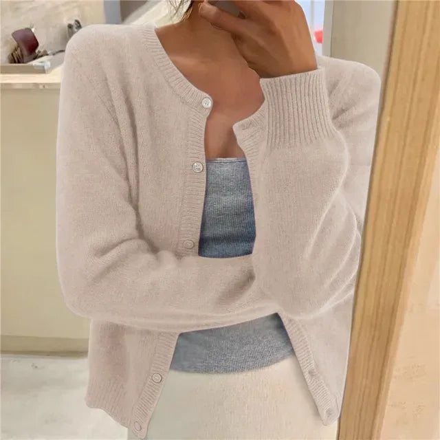 Beige knitted cardigan with fluffy texture, round neckline and ribbed cuffs worn open
