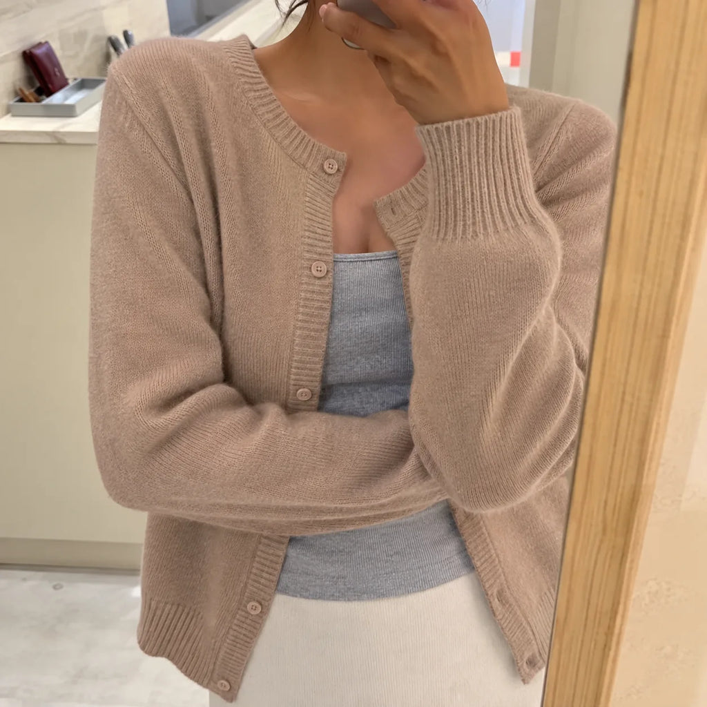 Taupe knitted cardigan with round neckline and button placket, worn over a grey camisole