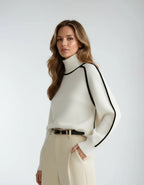 Side angle of the cream jumper highlighting the ribbed polo neck collar and black piped seam