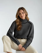 Detail view of the charcoal grey jumper highlighting the soft knit texture, ribbed cuffs and curved piping