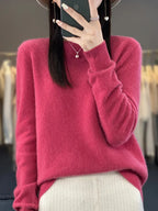 Black knit jumper detail showing ribbed cuff and round neckline on a relaxed silhouette