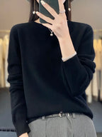 Dark grey jumper showing the ribbed hem and soft knit texture in close detail