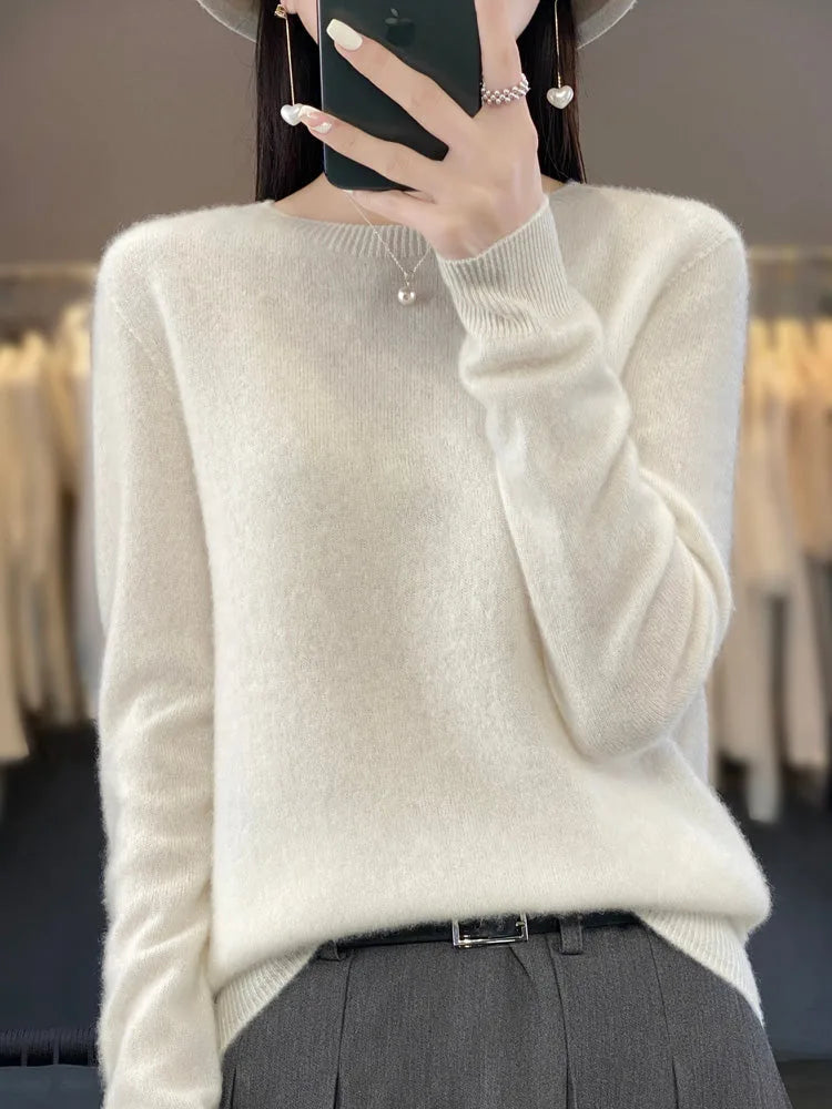 Ivory white jumper with ribbed neckline and cuffs styled with tailored grey trousers