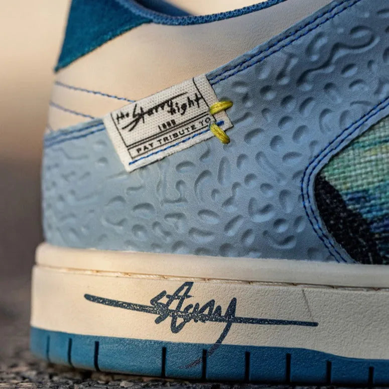 Macro shot of the heel tab woven label, textured side panel and signature print on the midsole