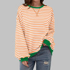 Side angle view highlighting the wide bishop sleeve and elasticated cuff of the striped sweatshirt