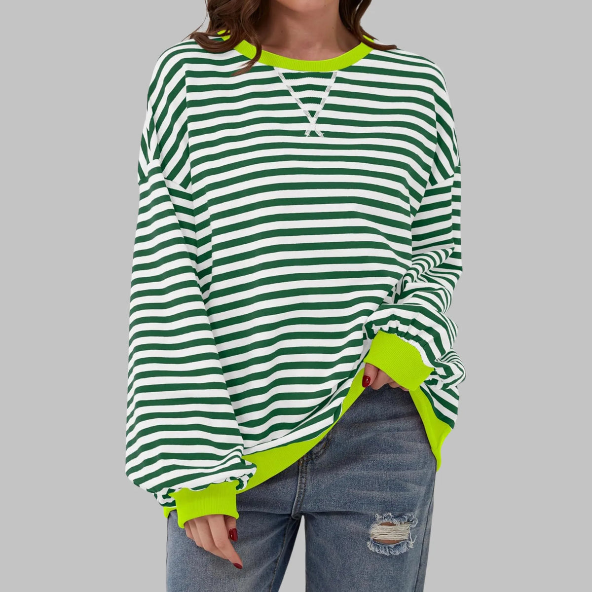 Front view of green and white striped sweatshirt with bright neon yellow ribbed neckline and cuffs