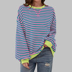 Front view of pink and teal striped sweatshirt with contrasting lime yellow ribbed neckline and cuffs