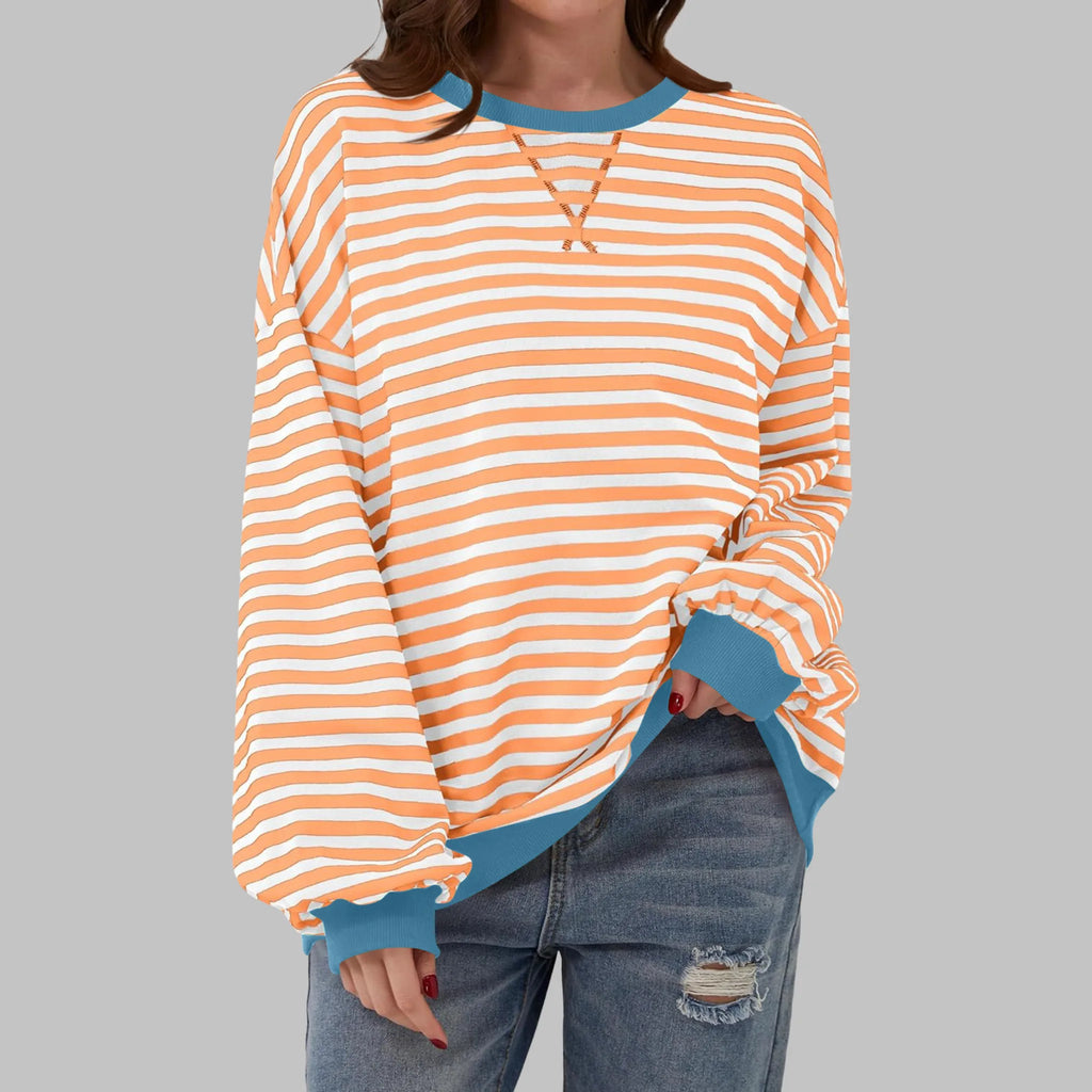 Front view of orange and white striped sweatshirt with contrasting blue ribbed neckline and cuffs
