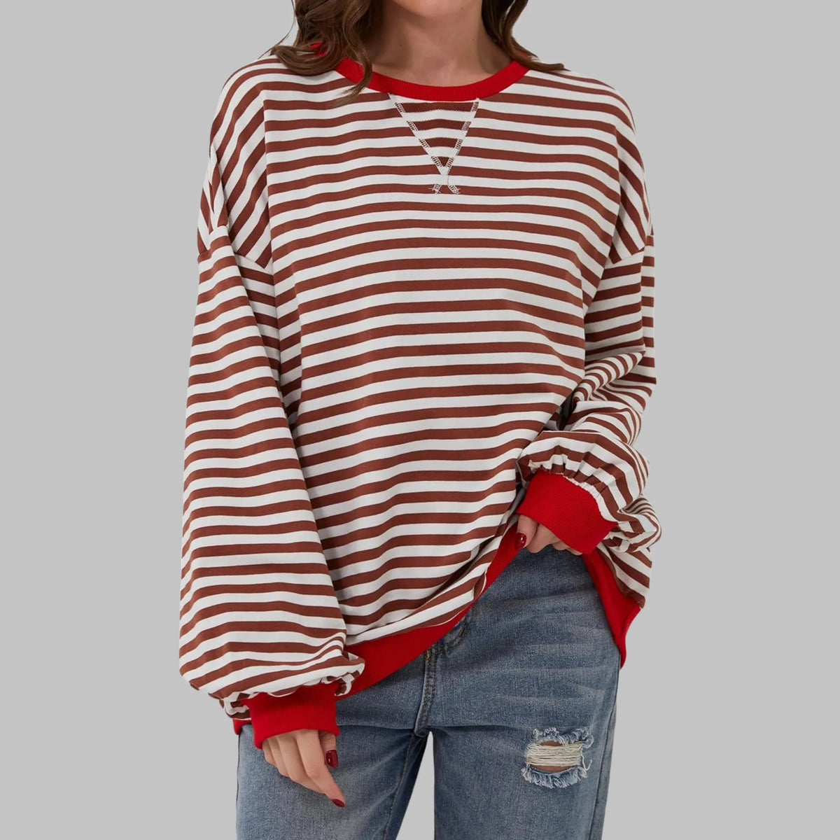 Front view of rust brown and white striped sweatshirt with contrasting red ribbed collar and cuffs