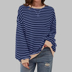 Close-up of drop shoulder seam and ribbed cuff detail on an oversized striped sweatshirt