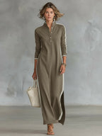 Woman walking in a khaki long-sleeve maxi dress with contrast white side stripes and a split hem