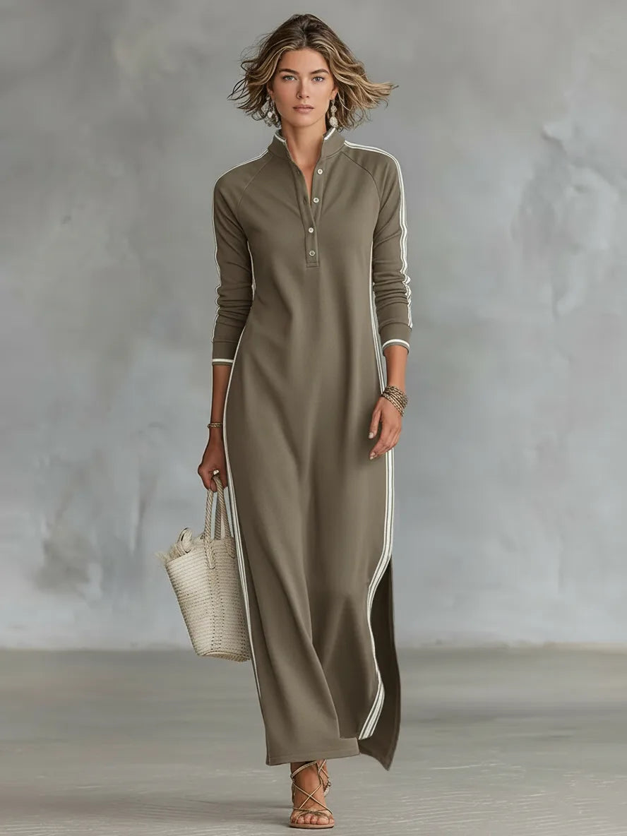 Woman walking in a khaki long-sleeve maxi dress with contrast white side stripes and a split hem