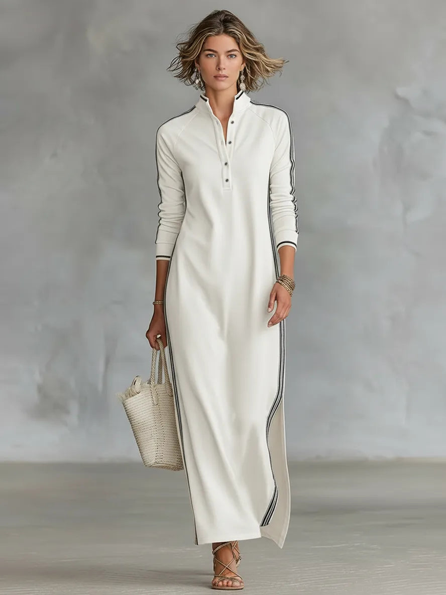Front view of an off-white maxi dress with a button placket, stand collar and black striped side trim