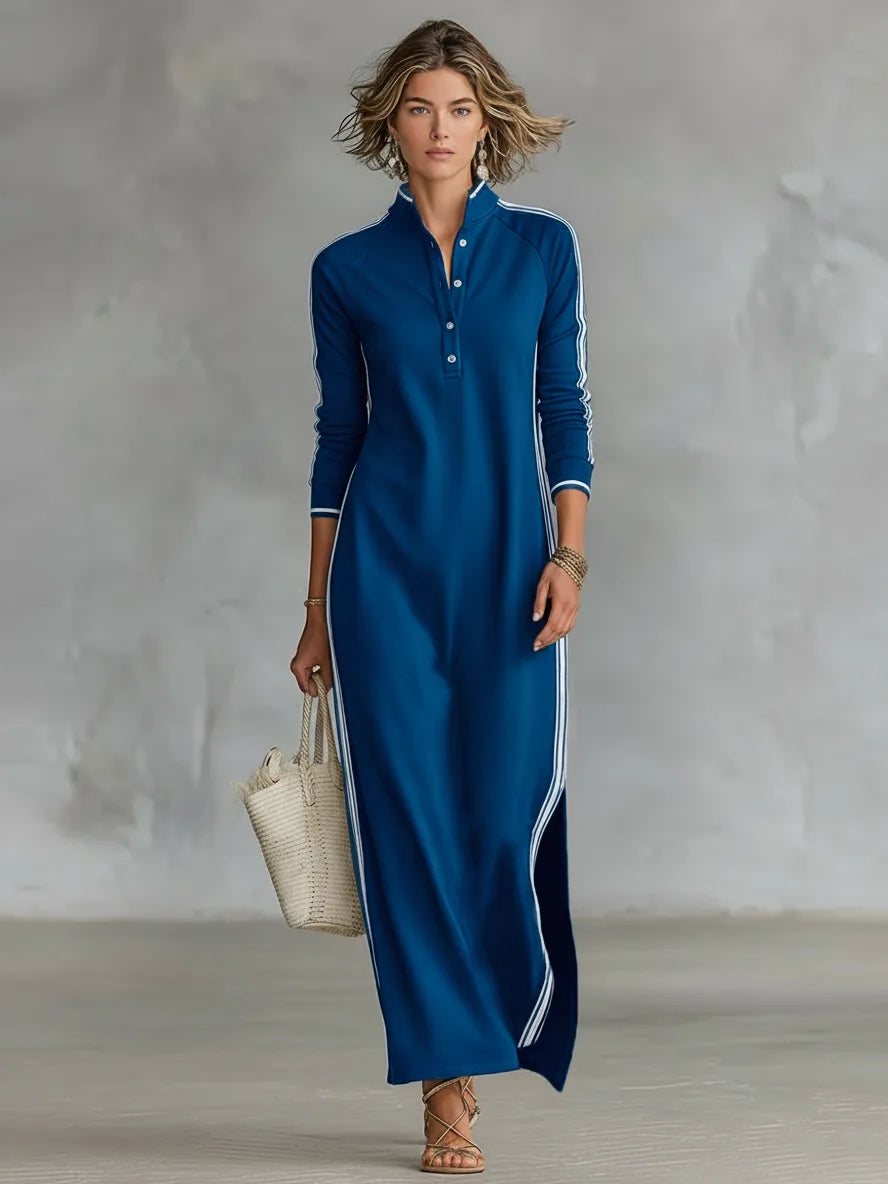 Woman modelling a royal blue long-sleeve maxi dress with white side stripes and buttoned collar detail