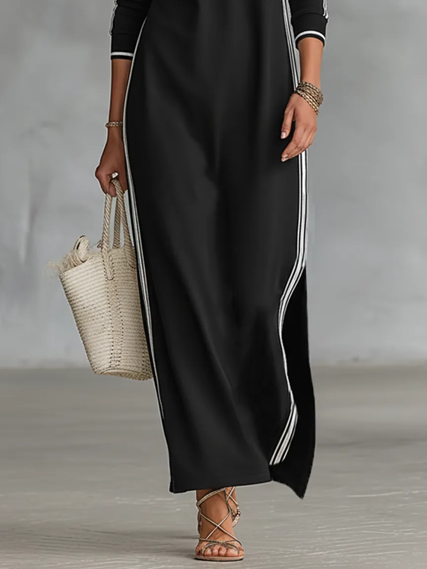 Cropped view of the black maxi dress showing the side split and white stripe detail along the leg